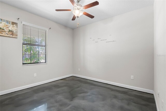 9931 Victory Gallop Loop, Ruskin, FL 33573 - unfurnished room with baseboards, concrete flooring, and a ceiling fan