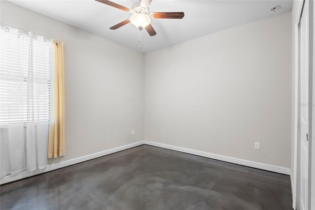 9931 Victory Gallop Loop, Ruskin, FL 33573 - spare room featuring concrete flooring, ceiling fan, and baseboards
