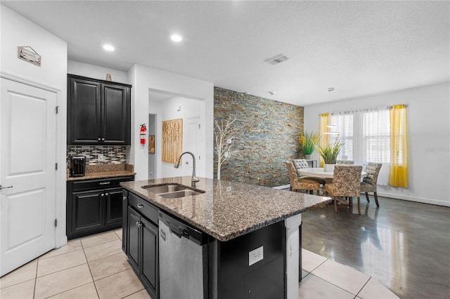 9931 Victory Gallop Loop, Ruskin, FL 33573 - kitchen with a sink, dishwasher, dark cabinetry, and dark stone counters