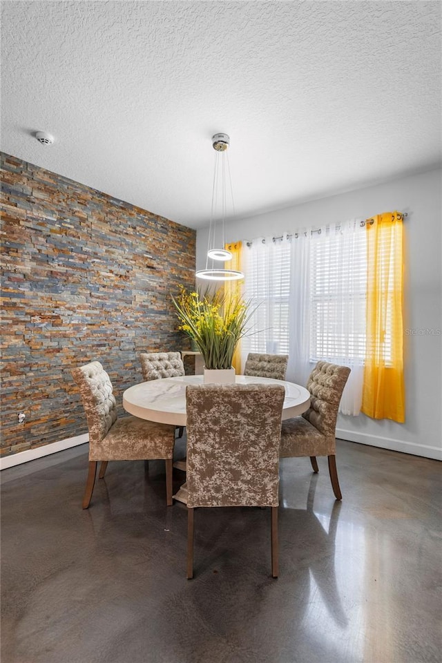 9931 Victory Gallop Loop, Ruskin, FL 33573 - dining room featuring a textured ceiling and baseboards