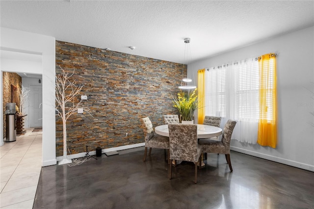 9931 Victory Gallop Loop, Ruskin, FL 33573 - dining area with baseboards, a textured ceiling, and concrete floors