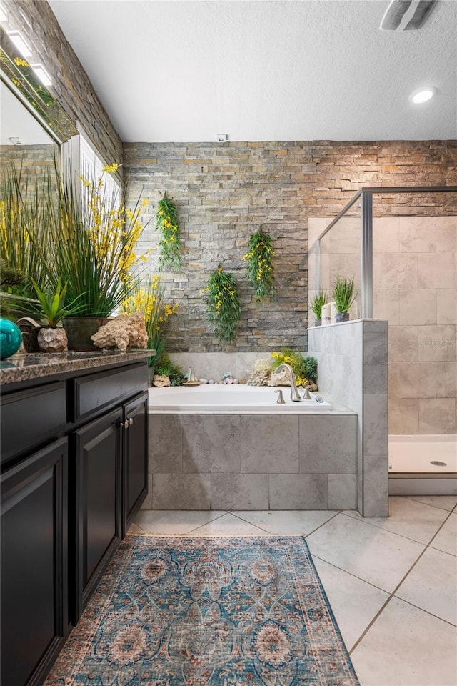 9931 Victory Gallop Loop, Ruskin, FL 33573 - bathroom with a shower stall, a bath, tile patterned flooring, vanity, and a textured ceiling
