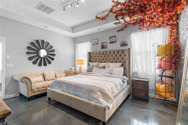 9931 Victory Gallop Loop, Ruskin, FL 33573 - bedroom with finished concrete flooring, a raised ceiling, and baseboards