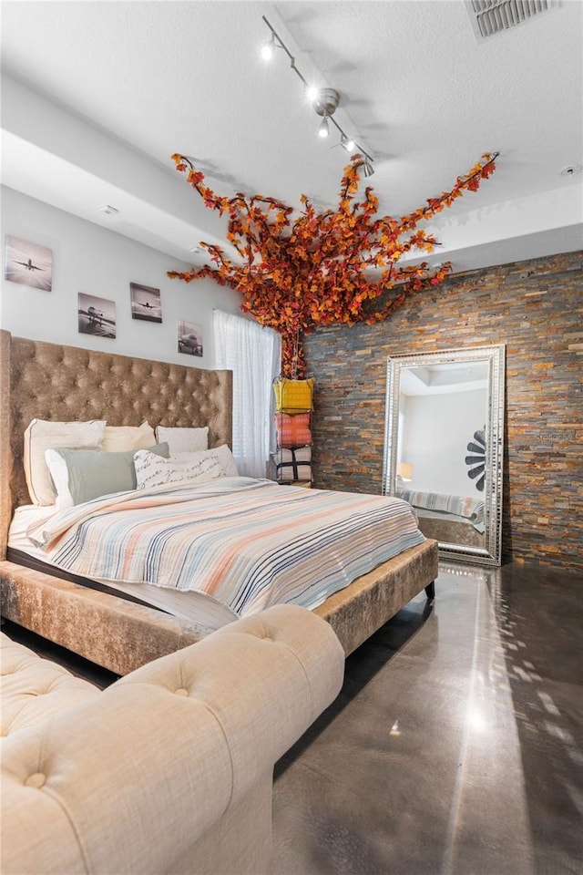 9931 Victory Gallop Loop, Ruskin, FL 33573 - bedroom with concrete flooring, track lighting, and a textured ceiling