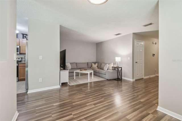4528 Winding River Way, Land O Lakes, FL 34639 - living area featuring wood finished floors, baseboards, and a textured ceiling