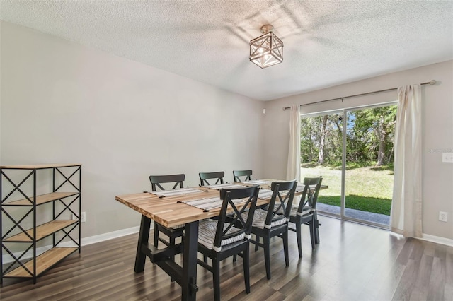 4528 Winding River Way, Land O Lakes, FL 34639 - dining area featuring dark wood-type flooring, a textured ceiling, a desk, and baseboards