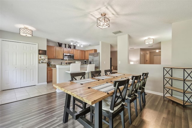 4528 Winding River Way, Land O Lakes, FL 34639 - dining room featuring wood finished floors, a textured ceiling, and baseboards
