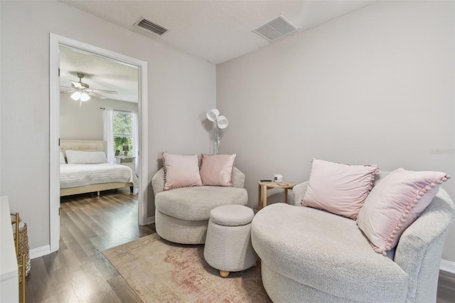4528 Winding River Way, Land O Lakes, FL 34639 - living area featuring wood finished floors, ceiling fan, and baseboards