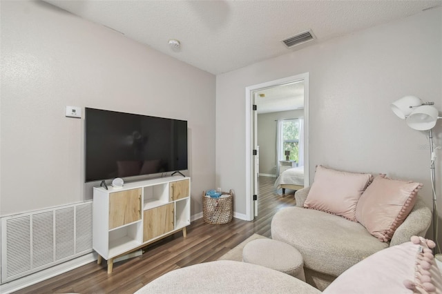 4528 Winding River Way, Land O Lakes, FL 34639 - living area featuring dark wood-style floors, baseboards, and a textured ceiling