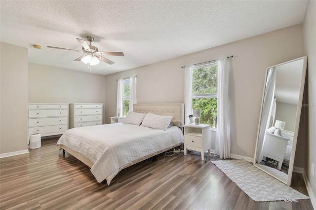 4528 Winding River Way, Land O Lakes, FL 34639 - bedroom with wood finished floors, a textured ceiling, baseboards, and ceiling fan