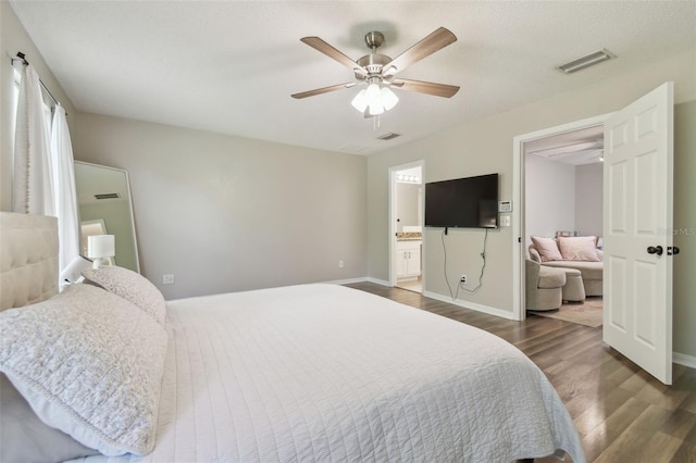4528 Winding River Way, Land O Lakes, FL 34639 - bedroom with wood finished floors, baseboards, a ceiling fan, and ensuite bath