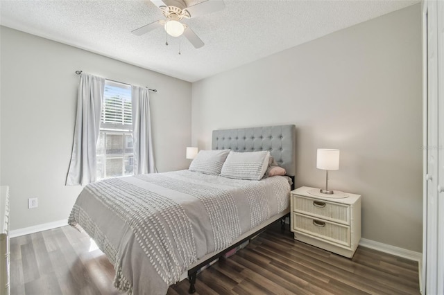4528 Winding River Way, Land O Lakes, FL 34639 - bedroom featuring dark wood-type flooring, baseboards, a textured ceiling, and ceiling fan