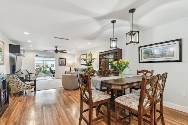 2960 59th St S Unit 614, Gulfport, FL 33707 - dining room featuring wood finished floors, a ceiling fan, baseboards, and recessed lighting