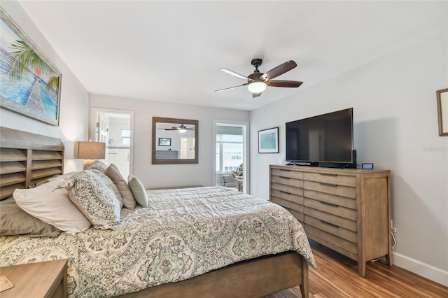2960 59th St S Unit 614, Gulfport, FL 33707 - bedroom with wood finished floors, baseboards, ceiling fan, and connected bathroom