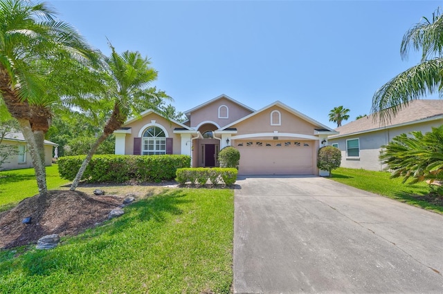 14502 Pond Cypress Way, Tampa, FL 33626 - view of front facade featuring stucco siding, a front lawn, and an attached garage
