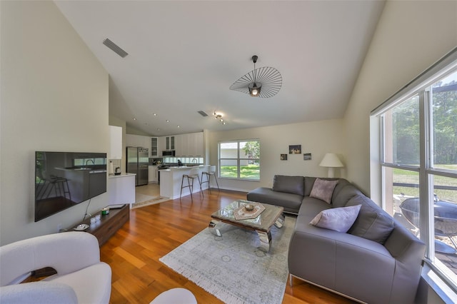 14502 Pond Cypress Way, Tampa, FL 33626 - living area with high vaulted ceiling and light wood-style flooring