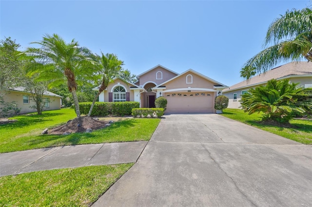 14502 Pond Cypress Way, Tampa, FL 33626 - ranch-style house with stucco siding, an attached garage, a front lawn, and driveway