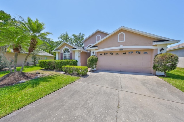 14502 Pond Cypress Way, Tampa, FL 33626 - view of front of home featuring stucco siding, an attached garage, concrete driveway, and a front yard