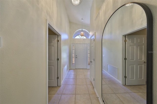 14502 Pond Cypress Way, Tampa, FL 33626 - foyer featuring light tile patterned flooring, arched walkways, and a chandelier
