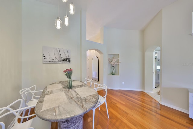 14502 Pond Cypress Way, Tampa, FL 33626 - dining space featuring arched walkways, wood finished floors, and baseboards