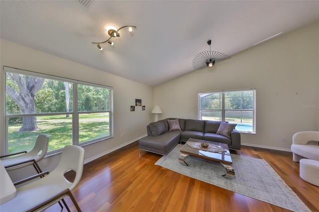 14502 Pond Cypress Way, Tampa, FL 33626 - living area featuring vaulted ceiling, wood finished floors, and baseboards