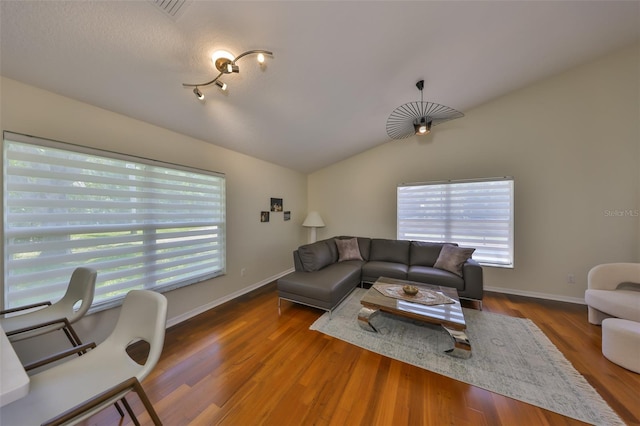 14502 Pond Cypress Way, Tampa, FL 33626 - living area featuring lofted ceiling, wood finished floors, and baseboards