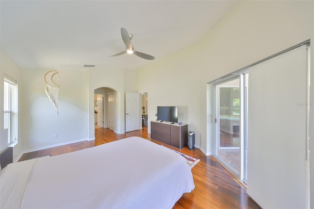 14502 Pond Cypress Way, Tampa, FL 33626 - bedroom with multiple windows, arched walkways, and wood finished floors