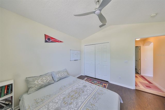 14502 Pond Cypress Way, Tampa, FL 33626 - bedroom featuring vaulted ceiling, wood finished floors, a closet, a textured ceiling, and ceiling fan