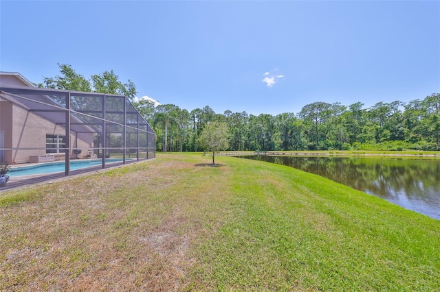 14502 Pond Cypress Way, Tampa, FL 33626 - view of green lawn with a water view, glass enclosure, and an outdoor pool