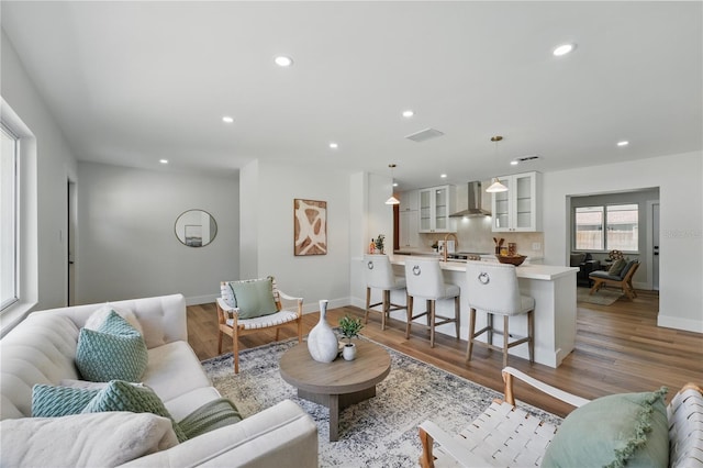 2815 Golfview Dr, Melbourne, FL 32901 - living area featuring baseboards, recessed lighting, and light wood-style flooring