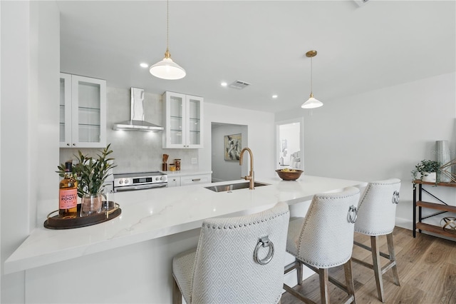 2815 Golfview Dr, Melbourne, FL 32901 - kitchen with wall chimney range hood, a sink, stainless steel range with electric stovetop, white cabinetry, and recessed lighting