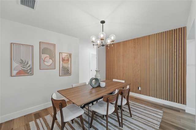 2815 Golfview Dr, Melbourne, FL 32901 - dining space with wood finished floors, baseboards, and a chandelier