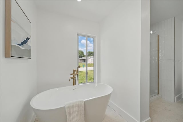 2815 Golfview Dr, Melbourne, FL 32901 - full bath featuring healthy amount of natural light, baseboards, a soaking tub, and a shower stall