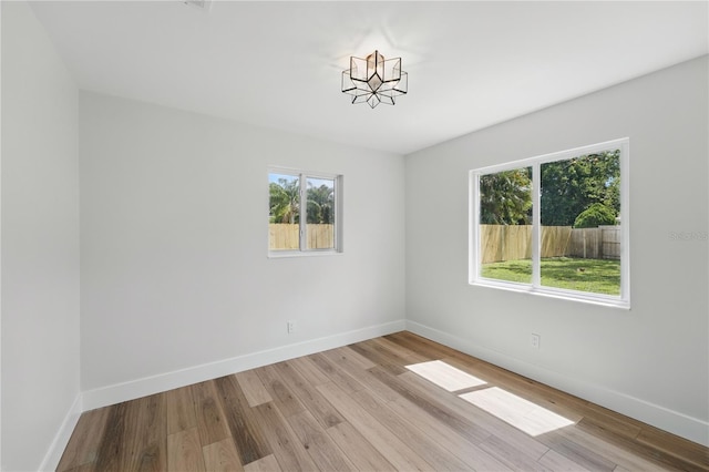 2815 Golfview Dr, Melbourne, FL 32901 - spare room featuring plenty of natural light, light wood-type flooring, and baseboards