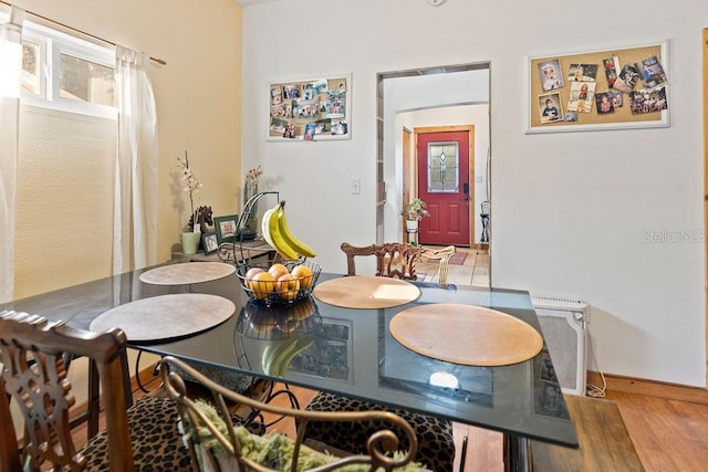 dining space with wood finished floors and baseboards