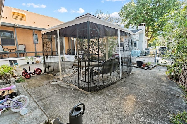 view of patio / terrace featuring a gate and fence