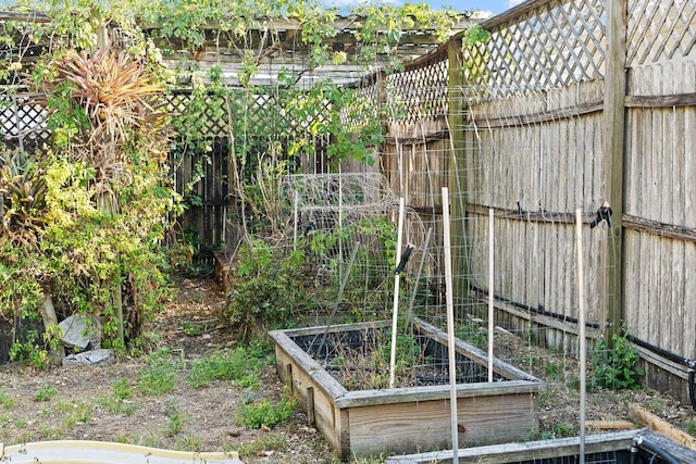 view of yard featuring a vegetable garden and fence