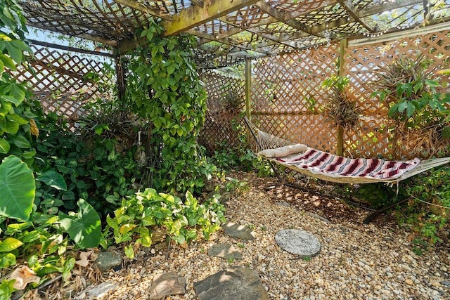 view of yard featuring a pergola and fence