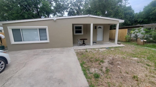 312 Dorothy Ave, Daytona Beach, FL 32117 - view of front of property featuring fence, stucco siding, and a patio