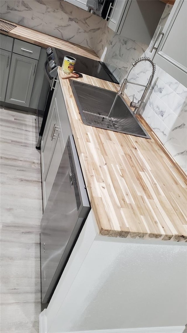312 Dorothy Ave, Daytona Beach, FL 32117 - kitchen featuring wooden counters and gray cabinetry