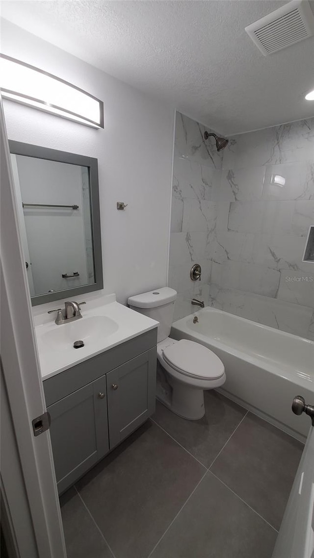 312 Dorothy Ave, Daytona Beach, FL 32117 - bathroom with a textured ceiling, vanity, toilet, and bathing tub / shower combination
