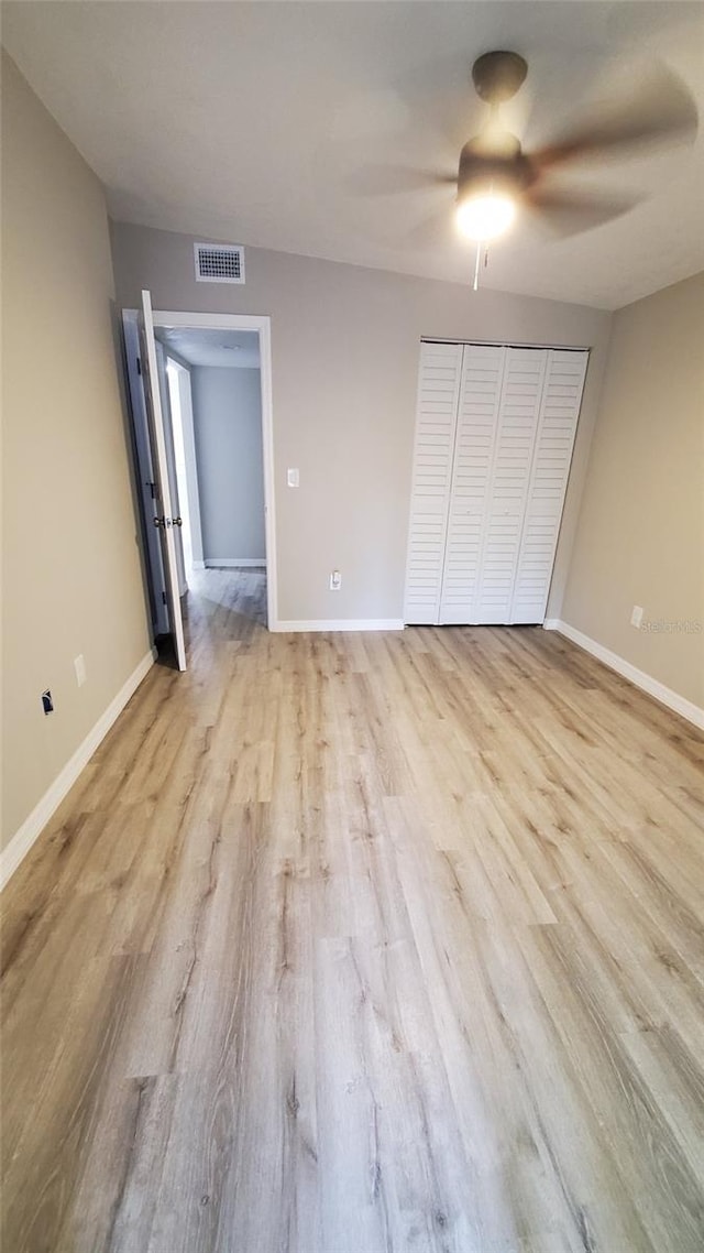 312 Dorothy Ave, Daytona Beach, FL 32117 - unfurnished bedroom with light wood-style floors, baseboards, a closet, and ceiling fan