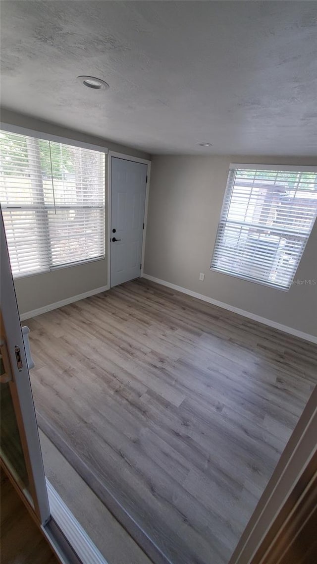312 Dorothy Ave, Daytona Beach, FL 32117 - entryway with baseboards, healthy amount of natural light, and wood finished floors