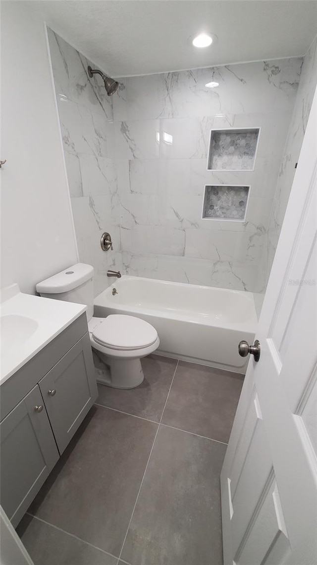 312 Dorothy Ave, Daytona Beach, FL 32117 - bathroom featuring vanity, toilet, shower / bathtub combination, and tile patterned flooring