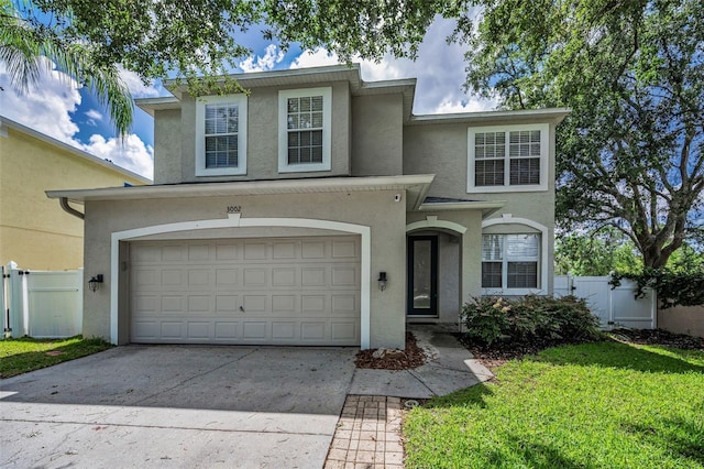 3002 Savannah Oaks Cir, Tarpon Springs, FL 34688 - traditional home with stucco siding, driveway, and an attached garage