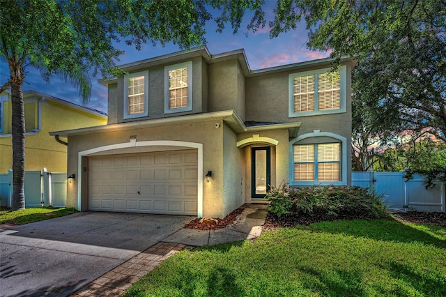 3002 Savannah Oaks Cir, Tarpon Springs, FL 34688 - traditional home with stucco siding, a garage, concrete driveway, and a gate