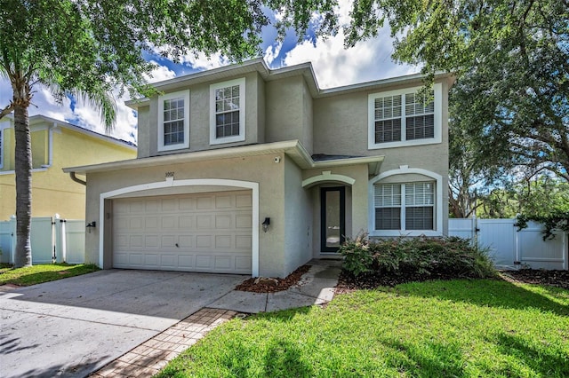 3002 Savannah Oaks Cir, Tarpon Springs, FL 34688 - view of front facade featuring stucco siding, a garage, concrete driveway, and a gate