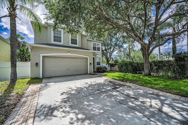 3002 Savannah Oaks Cir, Tarpon Springs, FL 34688 - traditional home with stucco siding, an attached garage, and concrete driveway