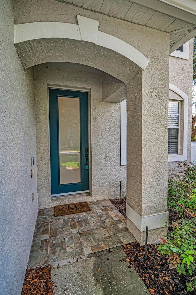 3002 Savannah Oaks Cir, Tarpon Springs, FL 34688 - property entrance with stucco siding