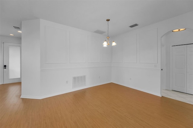 3002 Savannah Oaks Cir, Tarpon Springs, FL 34688 - empty room featuring a decorative wall, light wood-type flooring, a chandelier, recessed lighting, and baseboards